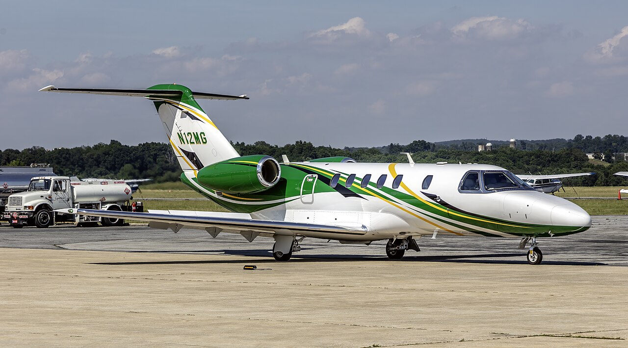 A Cessna Citation CJ4 business jet photographed side-on on an airport ramp.